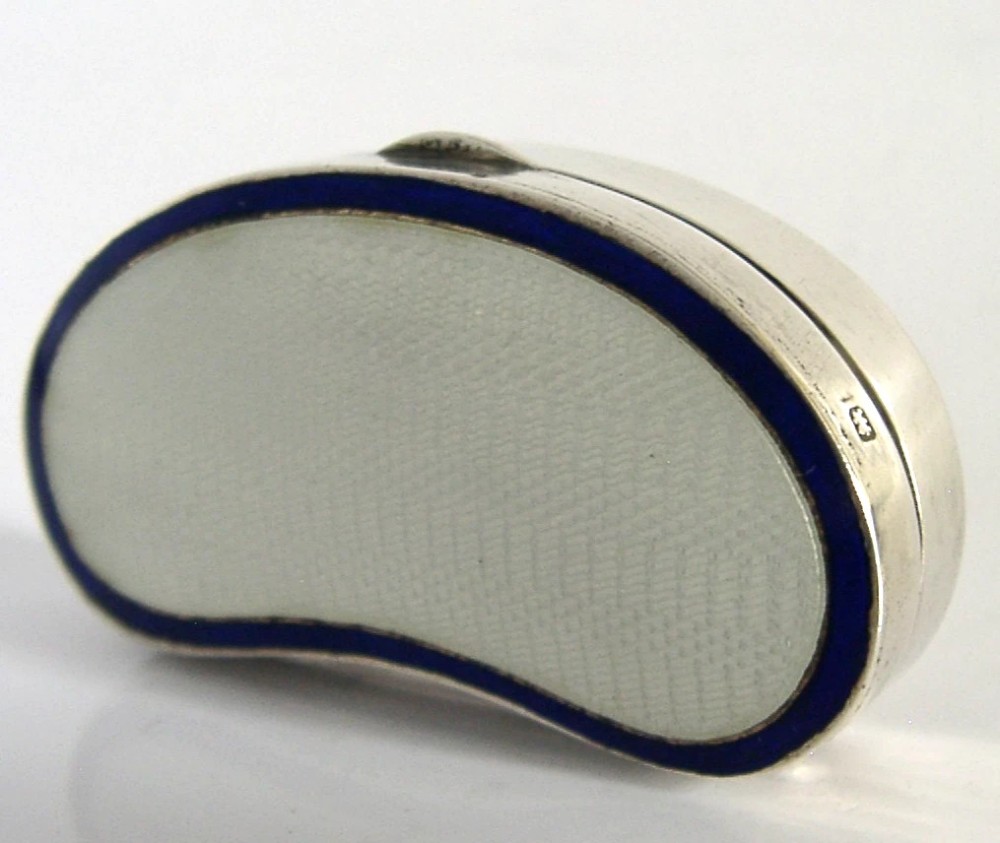 An Edwardian kidney-shaped sterling silver box featuring a white guilloche enamelled lid bordered with deep royal blue enamel. View X