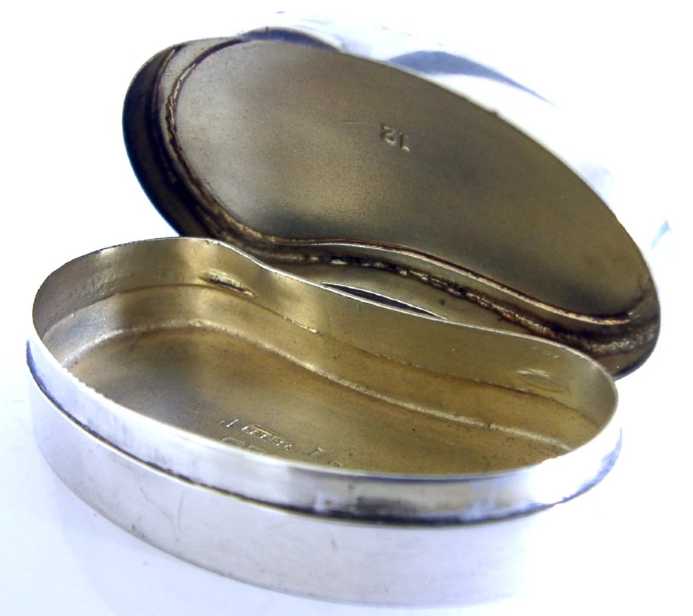 An Edwardian kidney-shaped sterling silver box featuring a white guilloche enamelled lid bordered with deep royal blue enamel. View XI