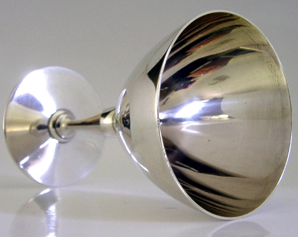 An Art Deco sterling silver cocktail goblet featuring a polished surface, a conical bowl, a turned stem, and a flat circular base. View III