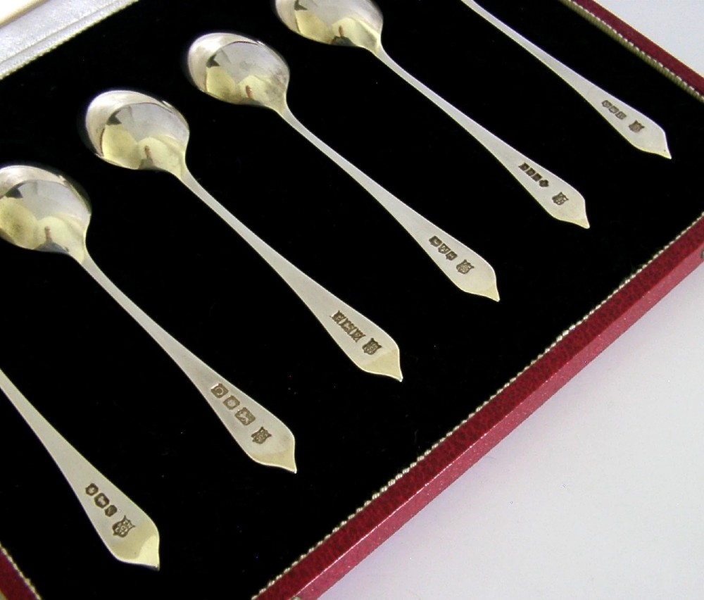 A set of six sterling silver teaspoons presented inside a fitted red velvet presentation box. View II