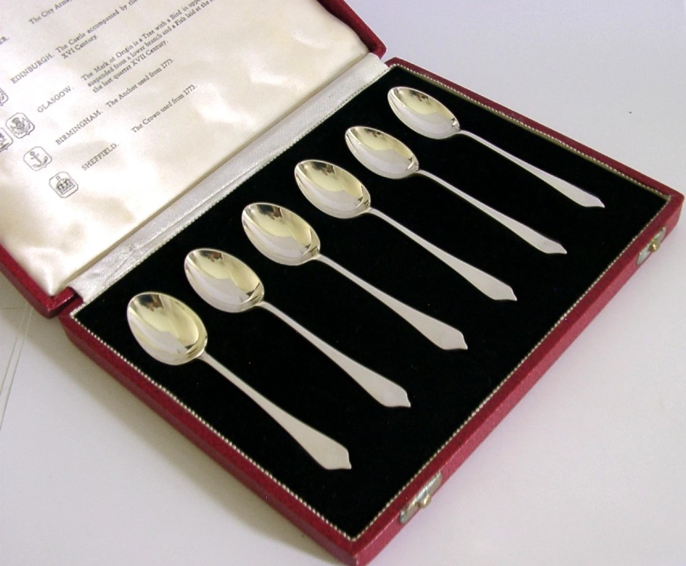 A set of six sterling silver teaspoons presented inside a fitted red velvet presentation box. View III