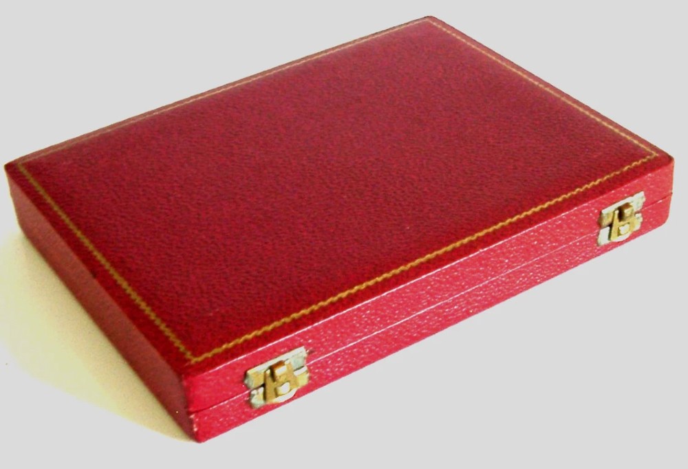 A set of six sterling silver teaspoons presented inside a fitted red velvet presentation box. View V