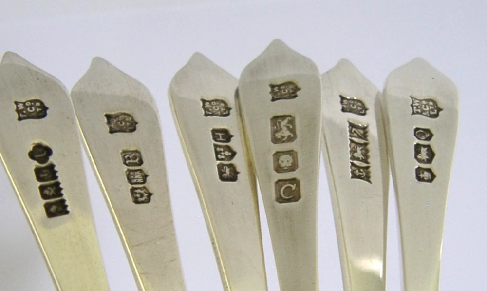 A set of six sterling silver teaspoons presented inside a fitted red velvet presentation box. View VI