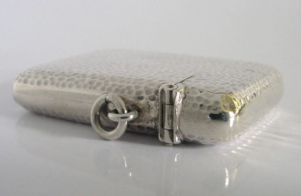 An Edwardian sterling silver pocket vesta case featuring a planished hammered surface and a central unengraved circular cartouche. View V