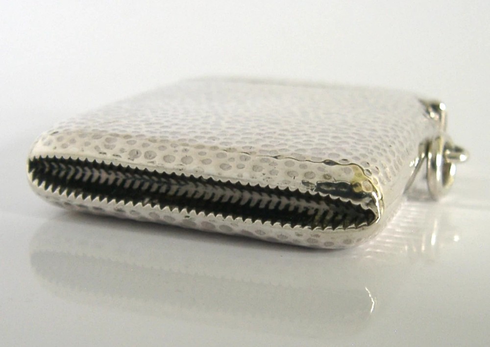 An Edwardian sterling silver pocket vesta case featuring a planished hammered surface and a central unengraved circular cartouche. View VI