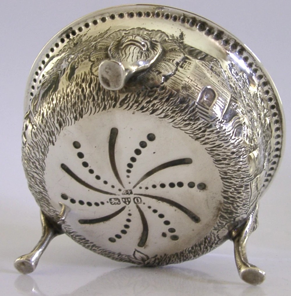A late Victorian sterling silver bowl decorated with chased pastoral scenes and supported by three lion-mask legs. View VIII