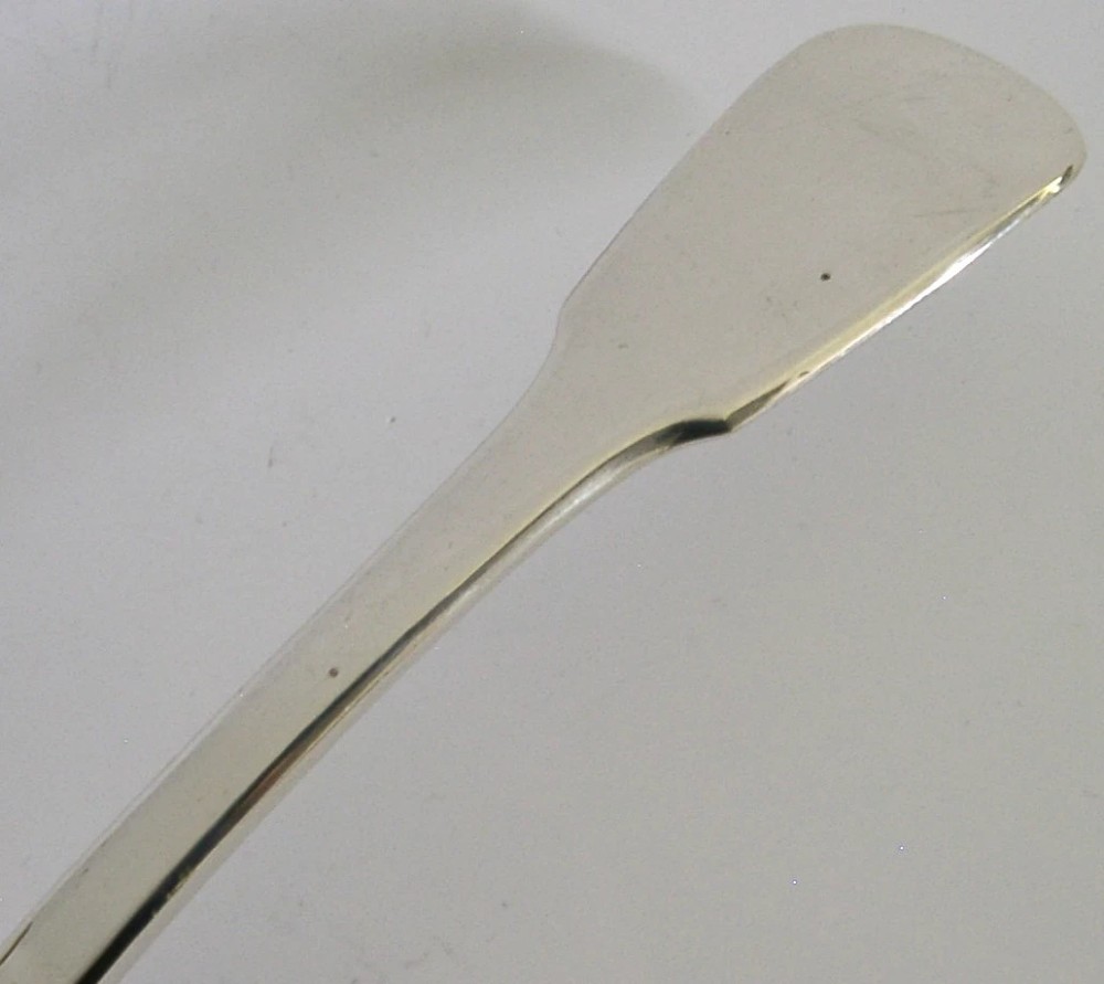 A George IV sterling silver fish slice featuring a hand-pierced central fish motif with leaf engraving and a contoured handle. View IV