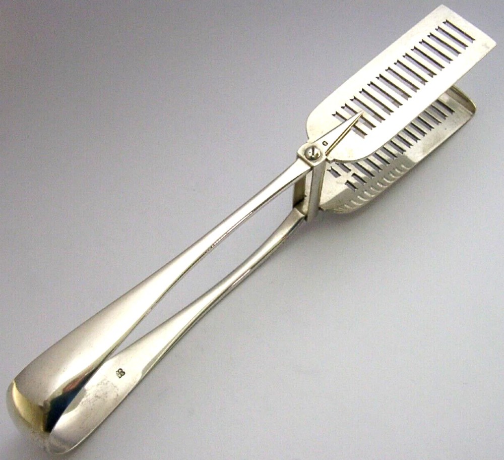 Victorian sterling silver serving tongs featuring slotted rectangular blades and a spring-hinged handle stamped with hallmarks.