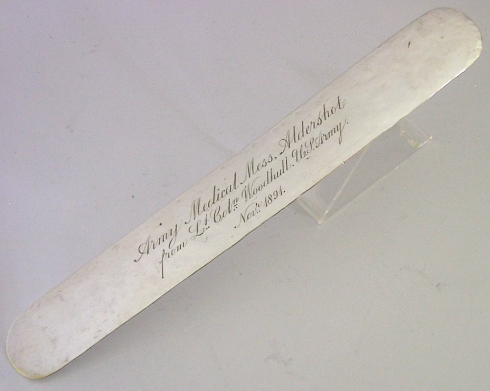 An engraved Victorian sterling silver page turner featuring script inscriptions along its flat blade.