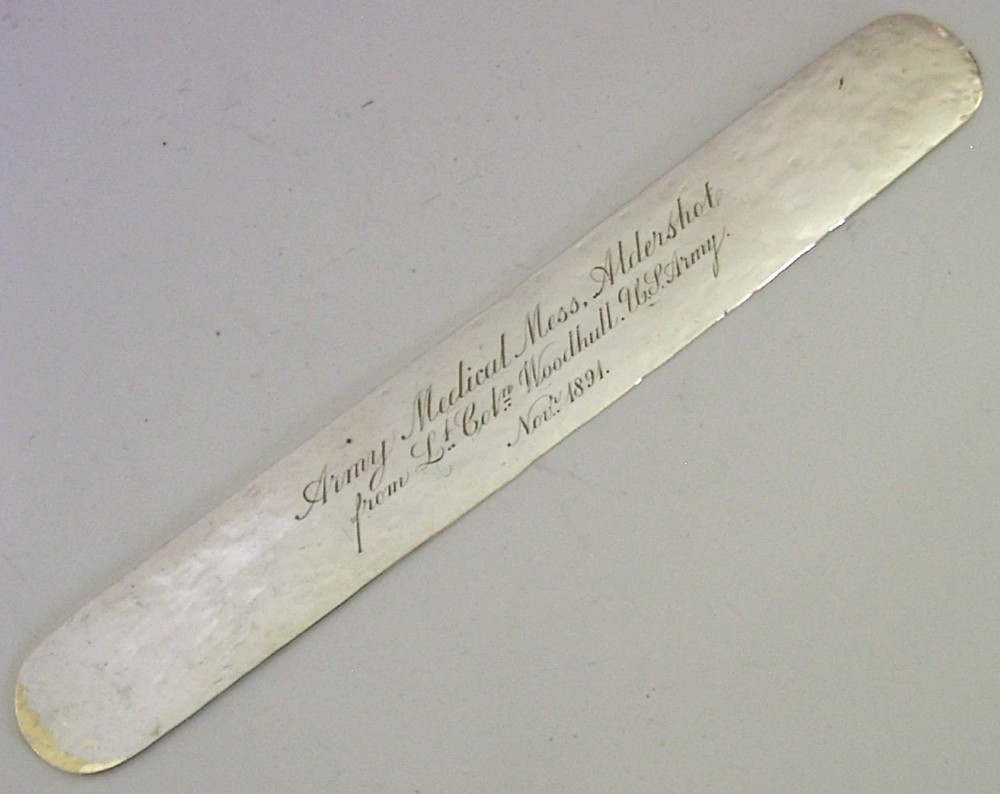 An engraved Victorian sterling silver page turner featuring script inscriptions along its flat blade. View IV