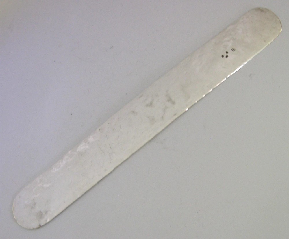 An engraved Victorian sterling silver page turner featuring script inscriptions along its flat blade. View V