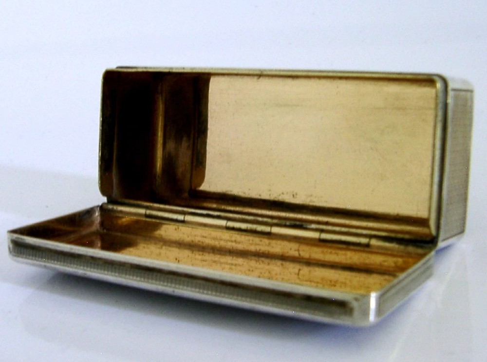An antique rectangular Austro-Hungarian solid silver box featuring intricate engraved scrollwork and an open hinged lid displaying a gilt interior. View IV