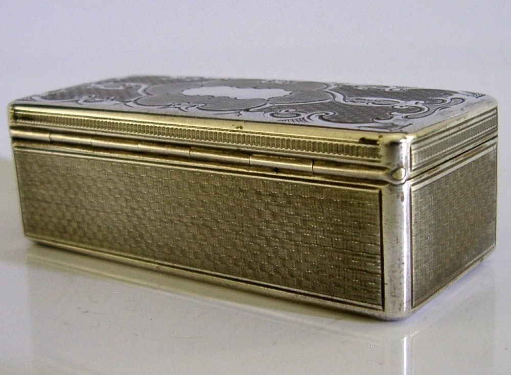An antique rectangular Austro-Hungarian solid silver box featuring intricate engraved scrollwork and an open hinged lid displaying a gilt interior. View VI