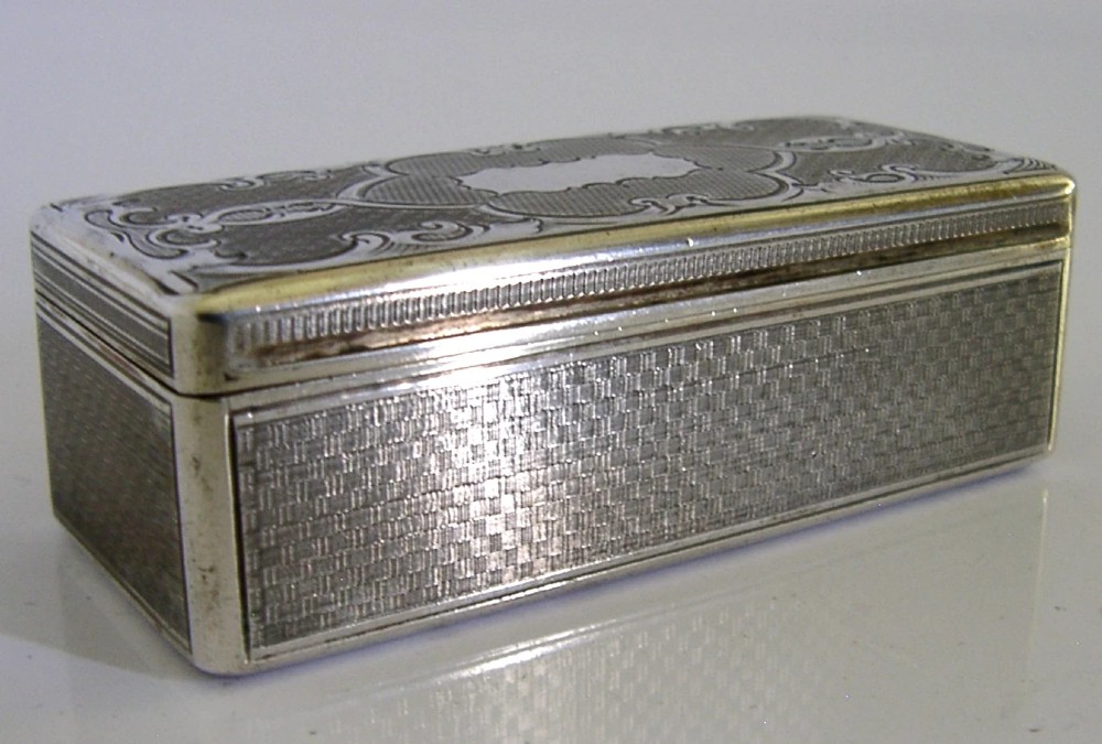 An antique rectangular Austro-Hungarian solid silver box featuring intricate engraved scrollwork and an open hinged lid displaying a gilt interior. View VII