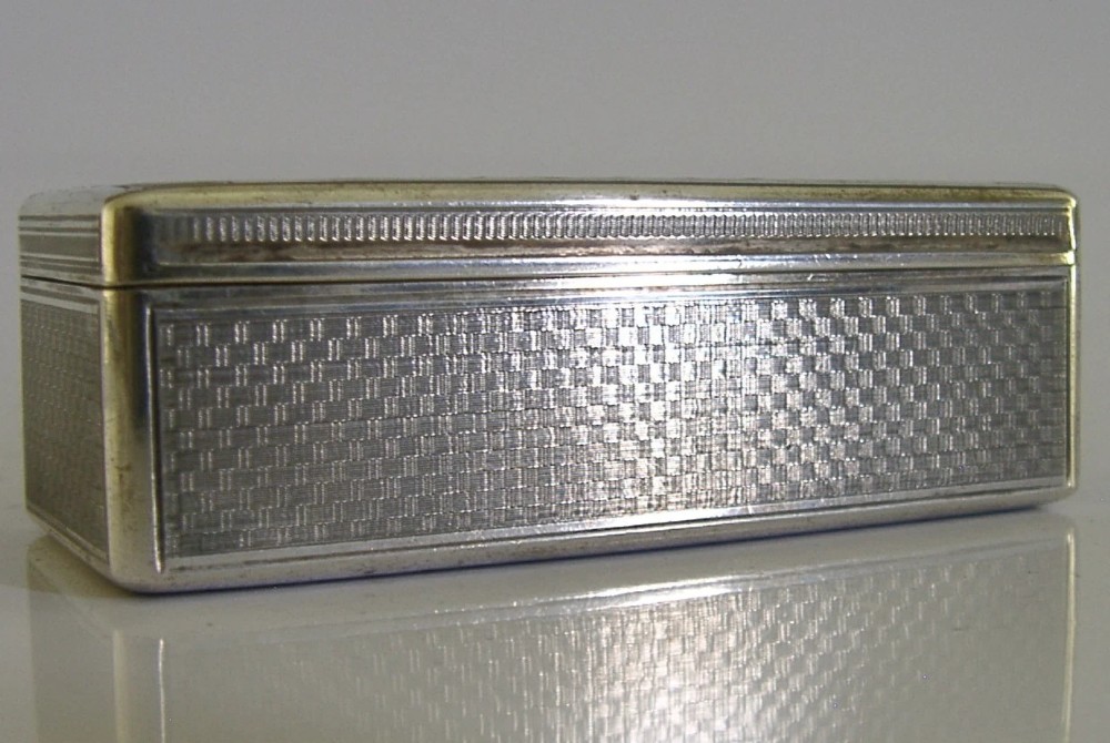 An antique rectangular Austro-Hungarian solid silver box featuring intricate engraved scrollwork and an open hinged lid displaying a gilt interior. View VIII