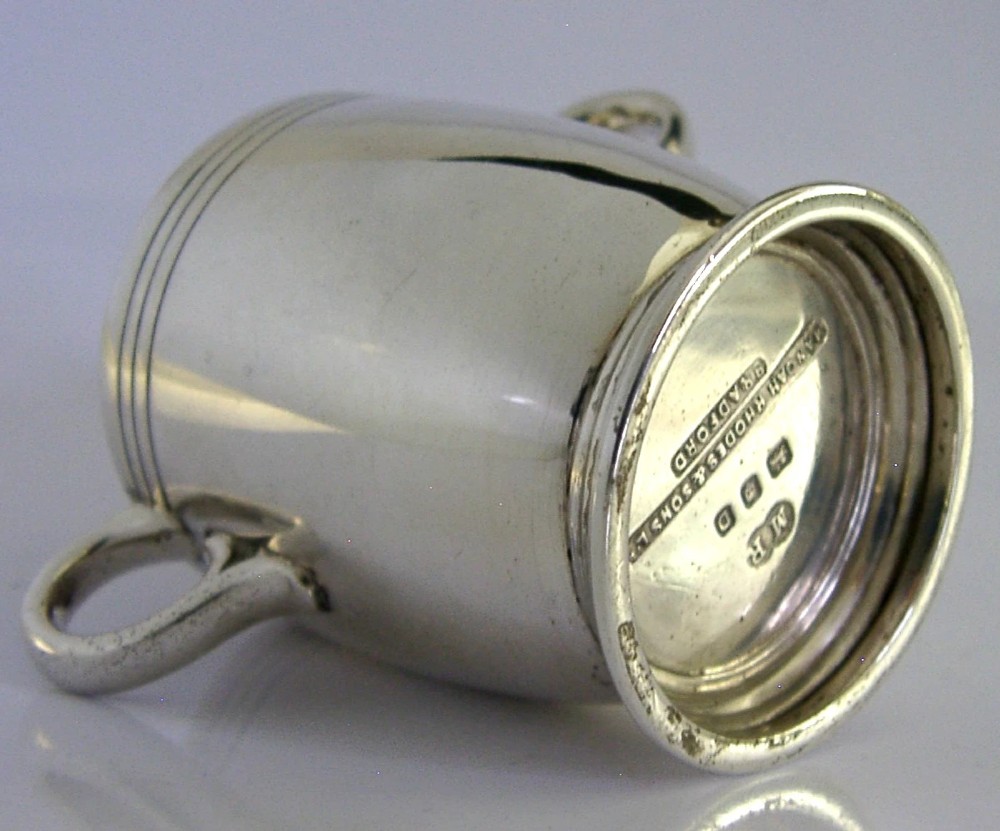 An Art Deco sterling silver twin-handled cup featuring horizontal incised line detailing, loop handles, a flared foot, and a gilt interior. View III