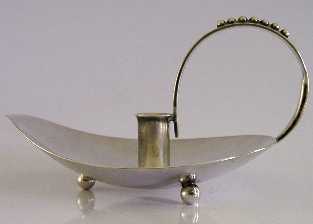 A sterling silver leaf-shaped chamberstick featuring a central candle socket and a looped handle accented with small silver spheres. View III