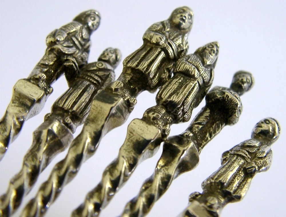 A set of six antique solid silver spoons featuring twisted stems, figural finials, and oval bowls. View II