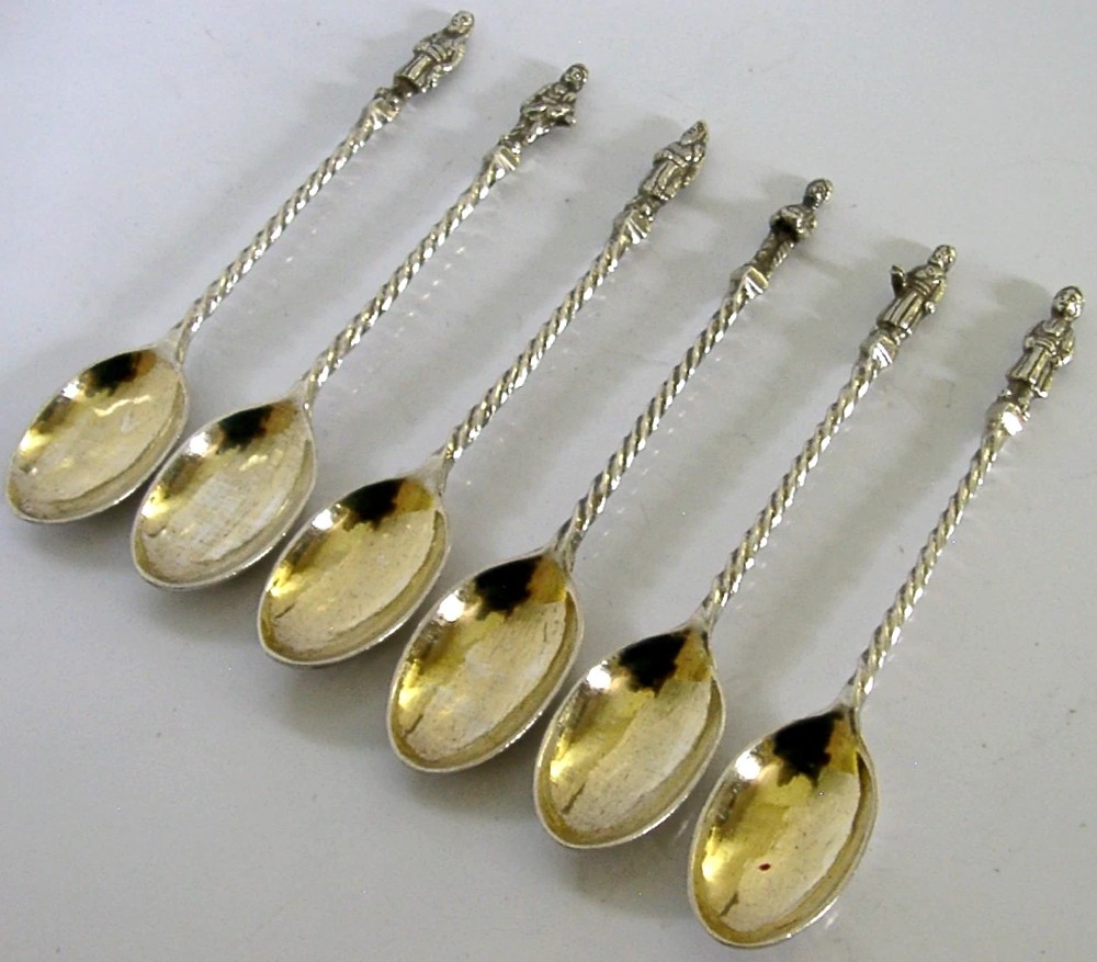 A set of six antique solid silver spoons featuring twisted stems, figural finials, and oval bowls. View III