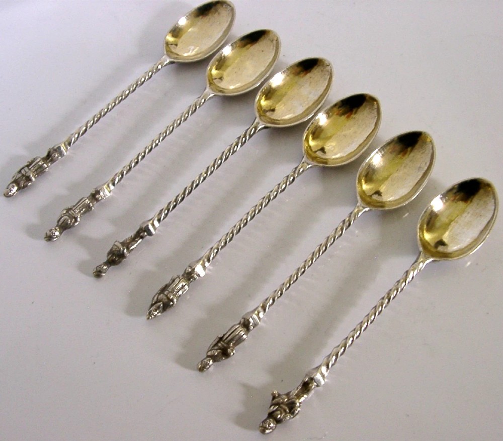 A set of six antique solid silver spoons featuring twisted stems, figural finials, and oval bowls. View VI