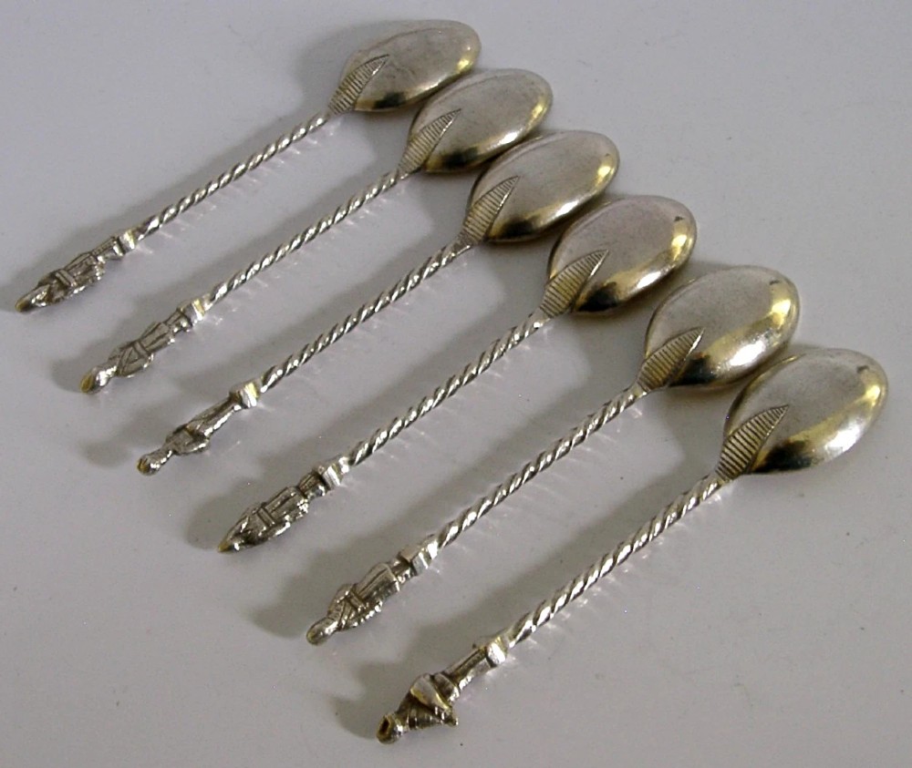A set of six antique solid silver spoons featuring twisted stems, figural finials, and oval bowls. View VII