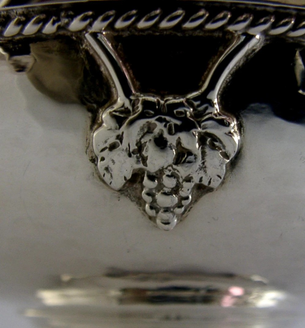 A hand-hammered sterling silver footed tazza featuring applied grape and vine motifs along the rim. View IV