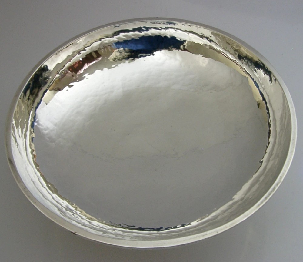 A hand-hammered sterling silver footed tazza featuring applied grape and vine motifs along the rim. View VIII