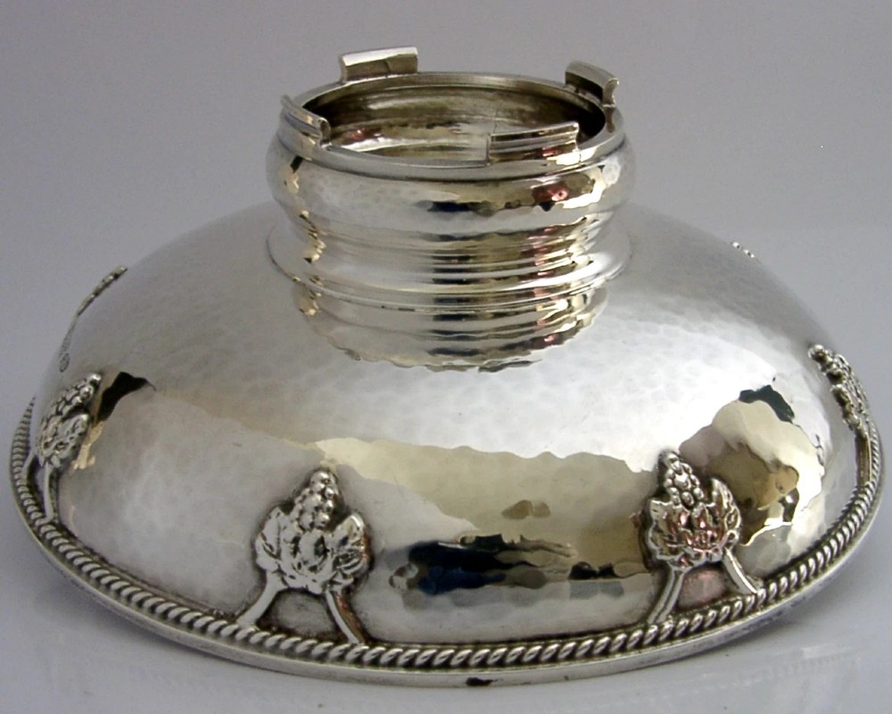 A hand-hammered sterling silver footed tazza featuring applied grape and vine motifs along the rim. View IX