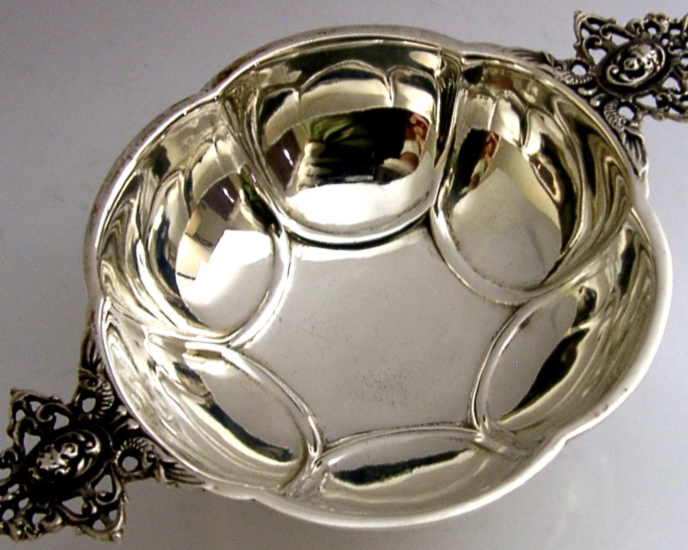 A Dutch solid silver lobed brandy bowl featuring twin ornate openwork cast handles with scrollwork details. View II
