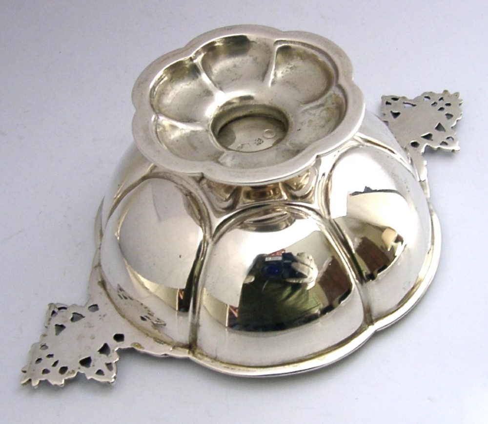 A Dutch solid silver lobed brandy bowl featuring twin ornate openwork cast handles with scrollwork details. View IV