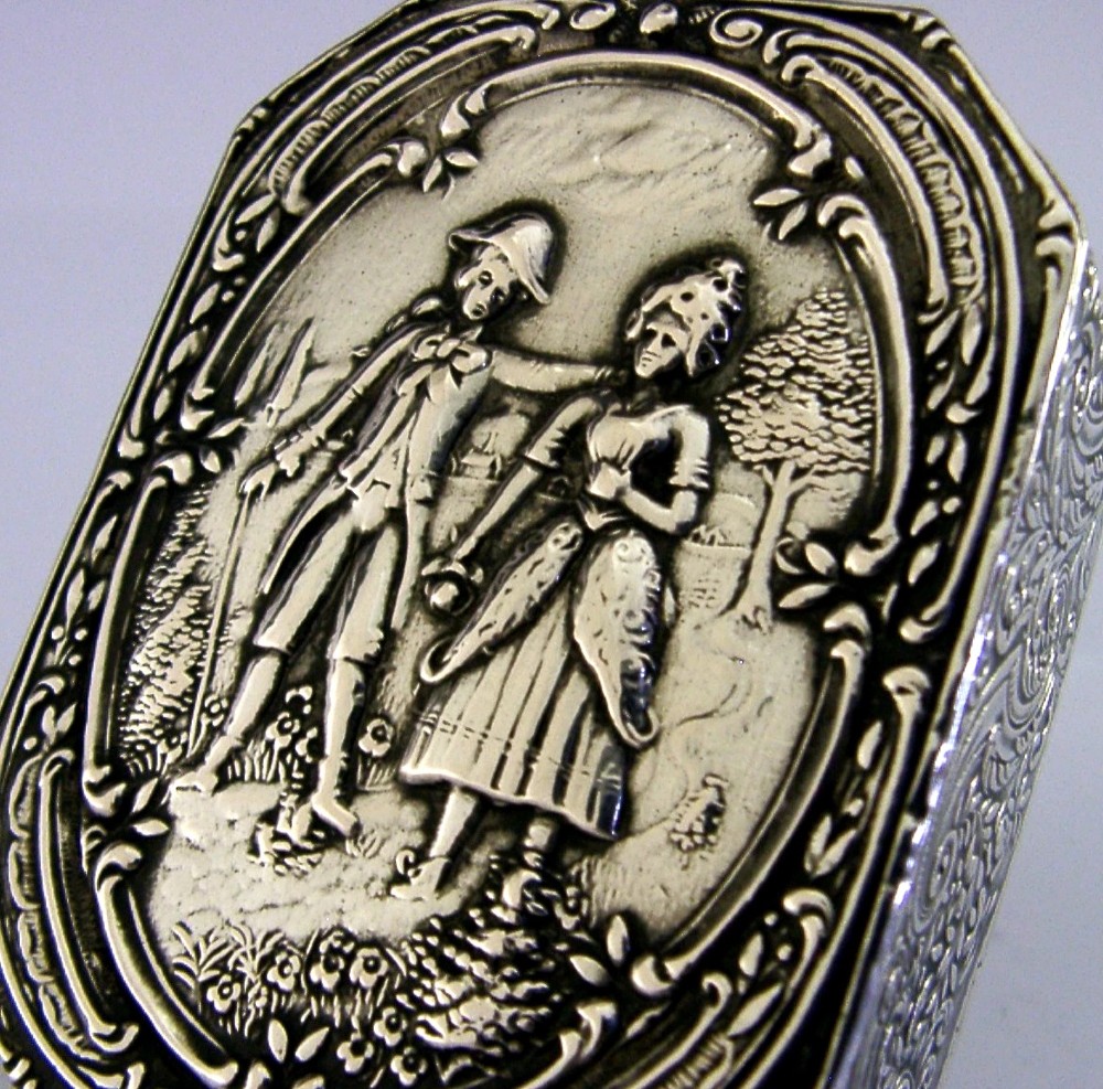 An octagonal antique silver table box featuring a detailed repousse scene of a couple in 18th-century attire within a scrollwork frame. View IV