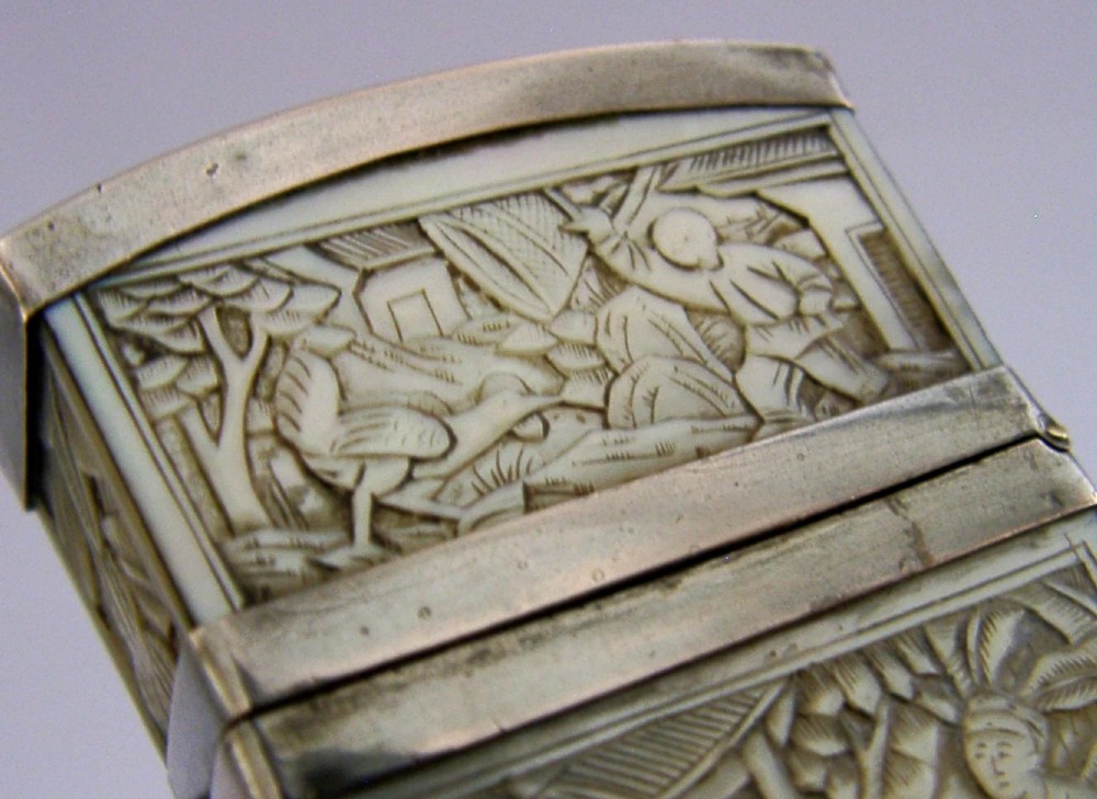 A small tapered antique Chinese export silver etui featuring intricately carved cream-coloured relief panels depicting figures in a garden setting. View III