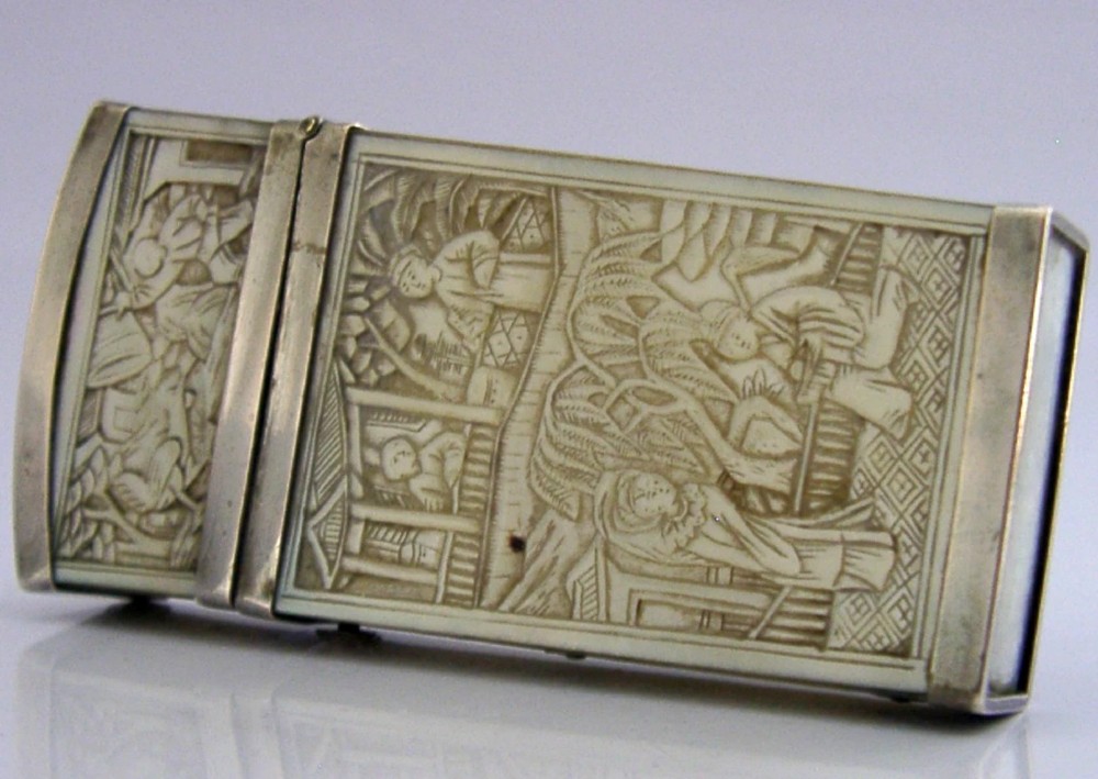 A small tapered antique Chinese export silver etui featuring intricately carved cream-coloured relief panels depicting figures in a garden setting. View IV
