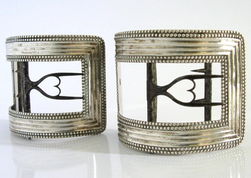 A pair of curved Georgian sterling silver shoe buckles featuring beaded borders and steel mechanism prongs. View III