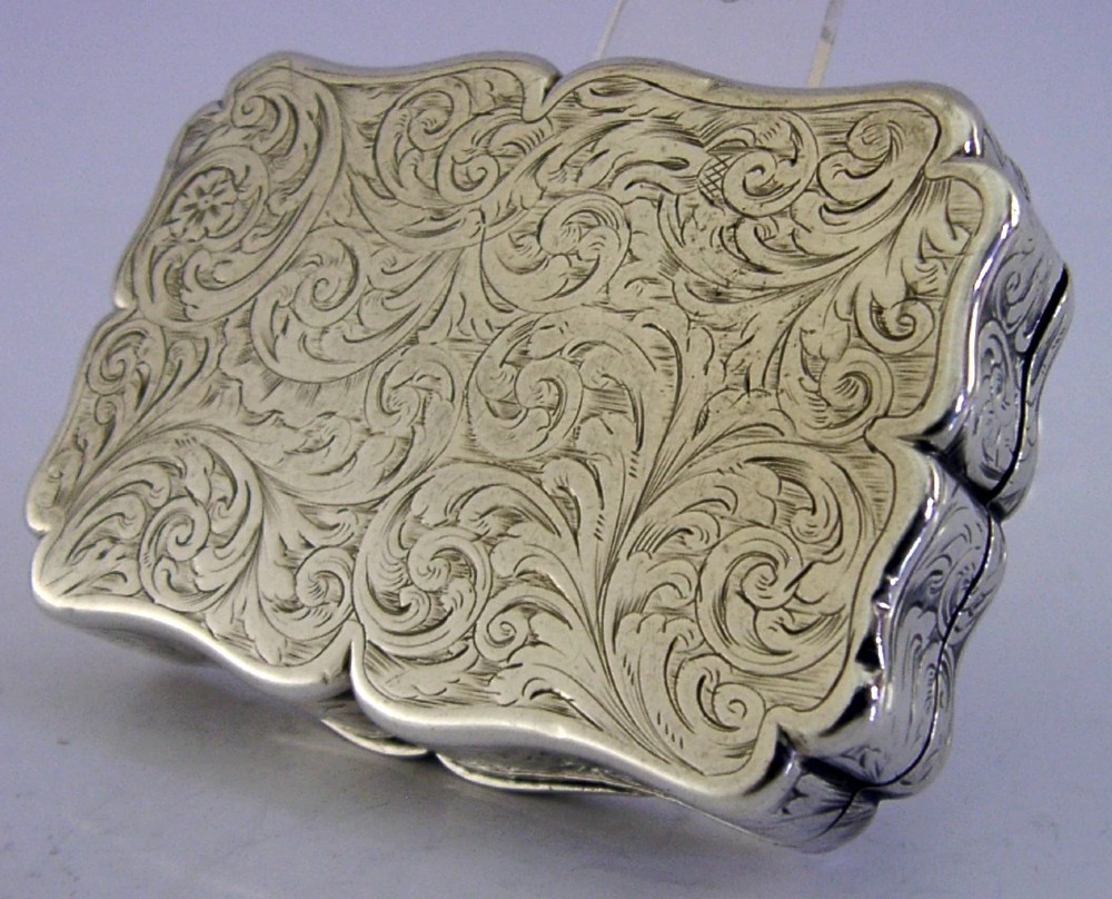 An engraved Victorian sterling silver snuff box with shaped edges, scrollwork border, and engraved inscription on the lid. View VI