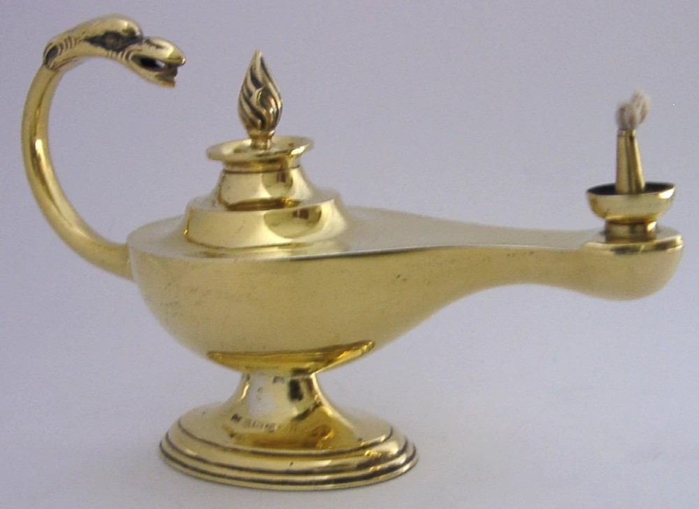 An antique Edwardian silver gilt cigar lighter crafted in the shape of a classical oil lamp with a serpent head handle and flame finial.