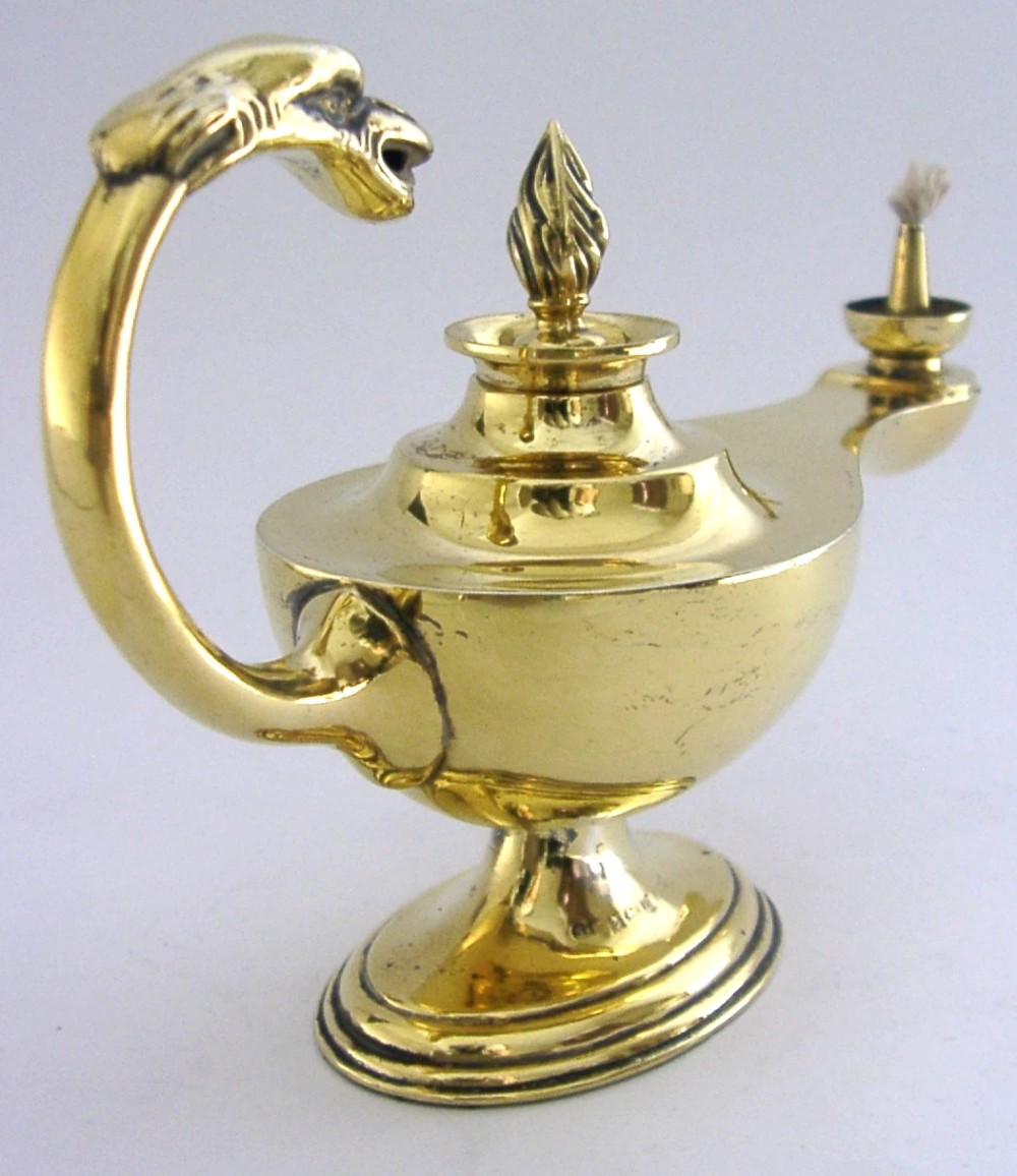 An antique Edwardian silver gilt cigar lighter crafted in the shape of a classical oil lamp with a serpent head handle and flame finial. View II