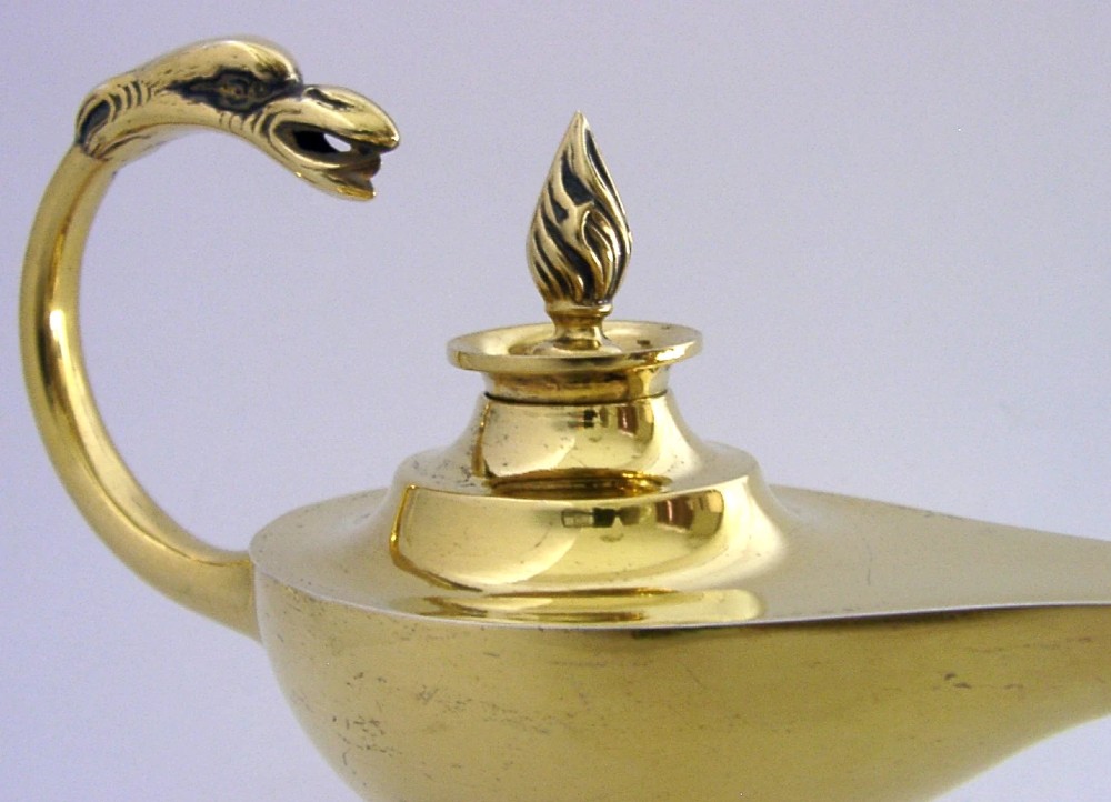 An antique Edwardian silver gilt cigar lighter crafted in the shape of a classical oil lamp with a serpent head handle and flame finial. View V