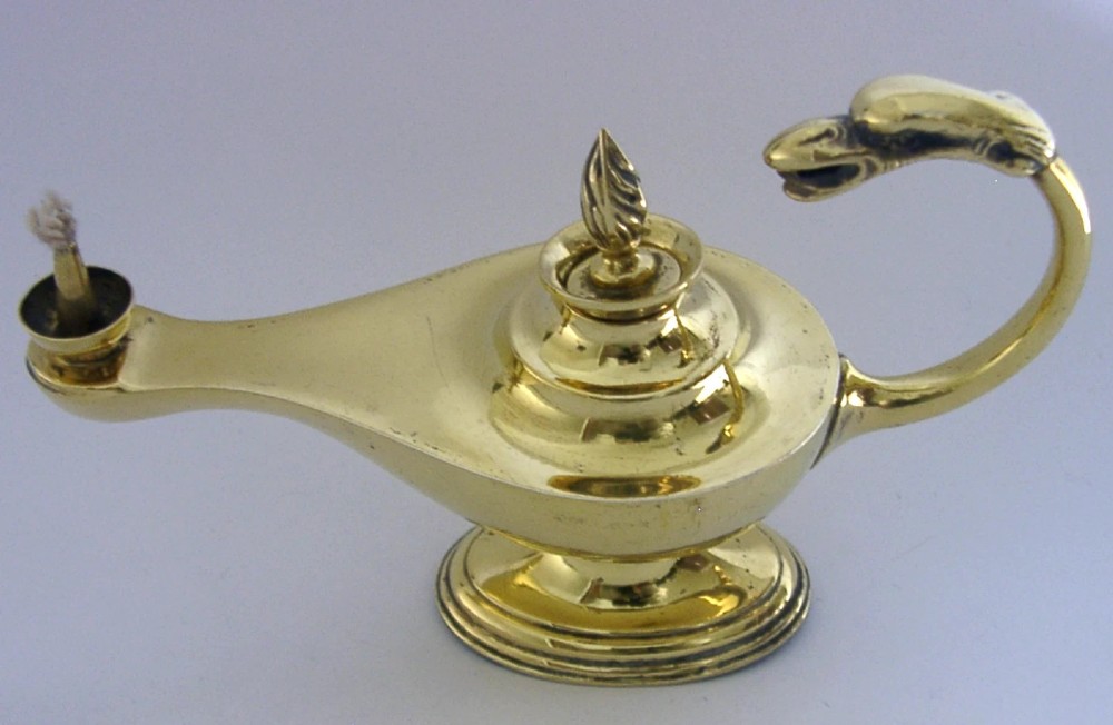 An antique Edwardian silver gilt cigar lighter crafted in the shape of a classical oil lamp with a serpent head handle and flame finial. View VII