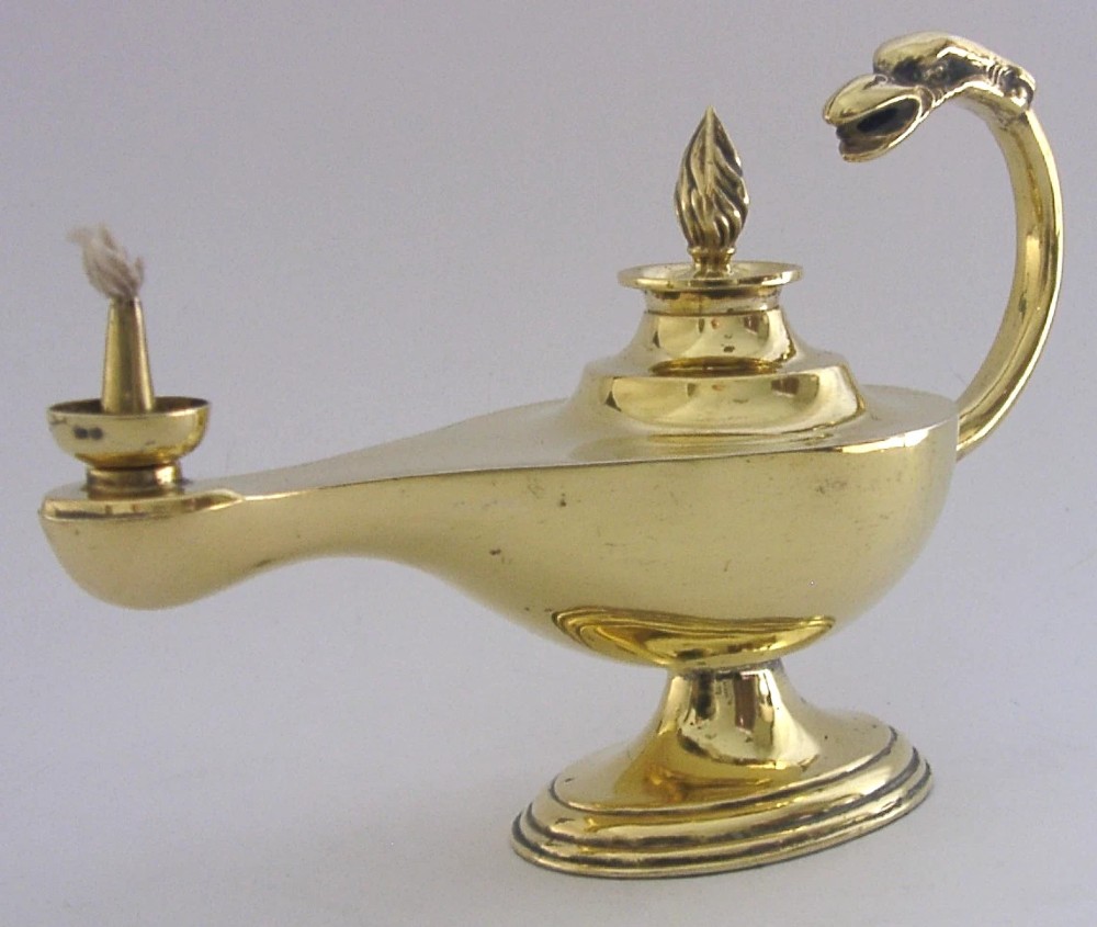 An antique Edwardian silver gilt cigar lighter crafted in the shape of a classical oil lamp with a serpent head handle and flame finial. View IX