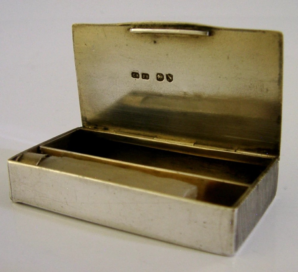 A Victorian sterling silver combination vesta case and go-to-bed taper holder with its hinged lid open. View II