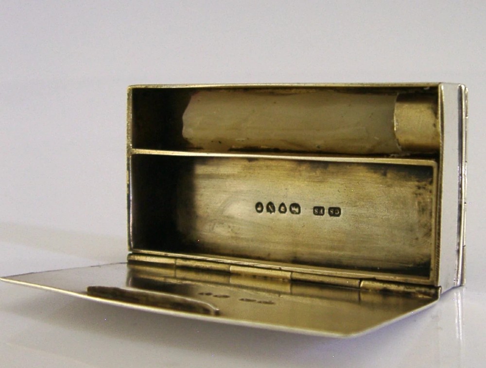 A Victorian sterling silver combination vesta case and go-to-bed taper holder with its hinged lid open. View V