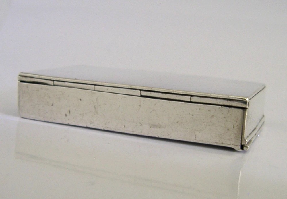 A Victorian sterling silver combination vesta case and go-to-bed taper holder with its hinged lid open. View VIII