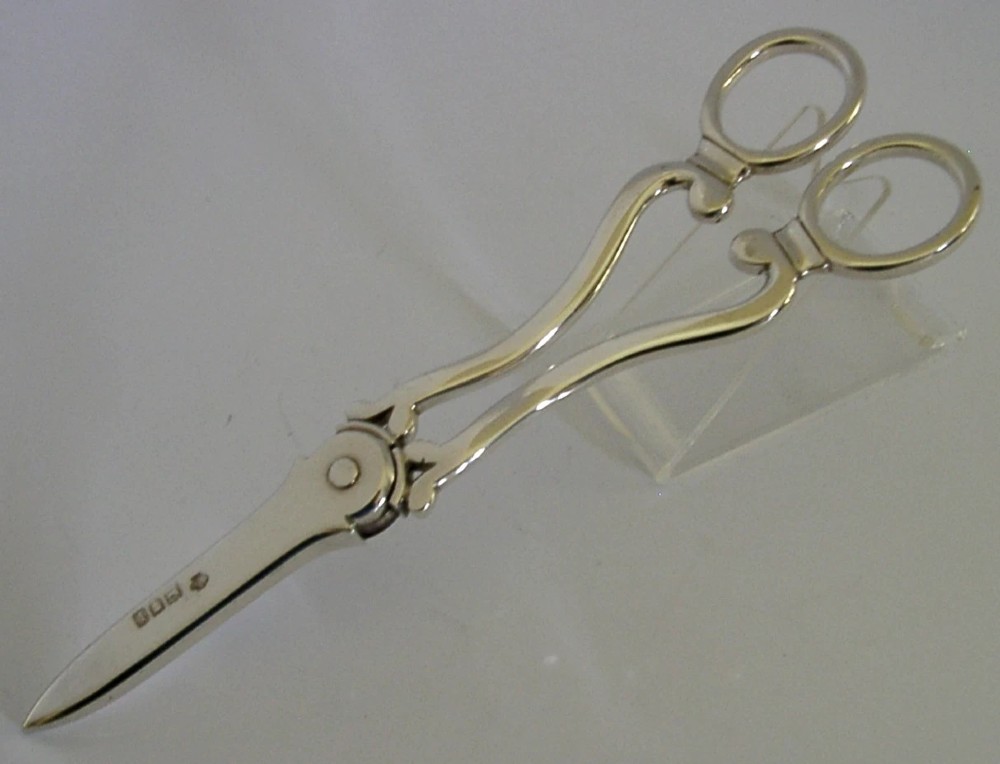 Antique Edwardian sterling silver grape shears presented inside an open, dark fitted case with a blue velvet and satin lining. View IX