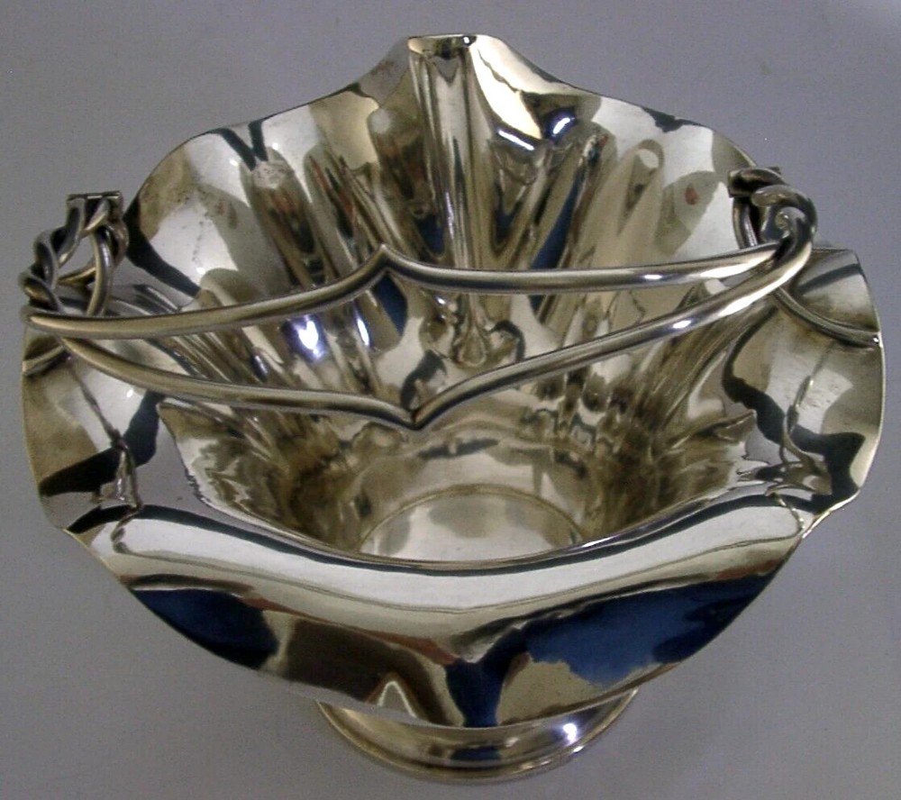 An antique solid silver Art Nouveau basket bowl with a fluted, lobed rim and an overhead twisted wire swing handle. View VII