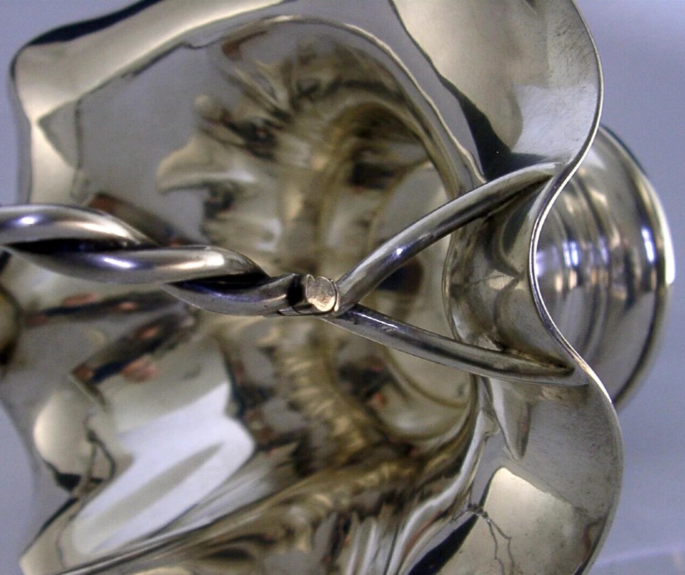 An antique solid silver Art Nouveau basket bowl with a fluted, lobed rim and an overhead twisted wire swing handle. View VIII
