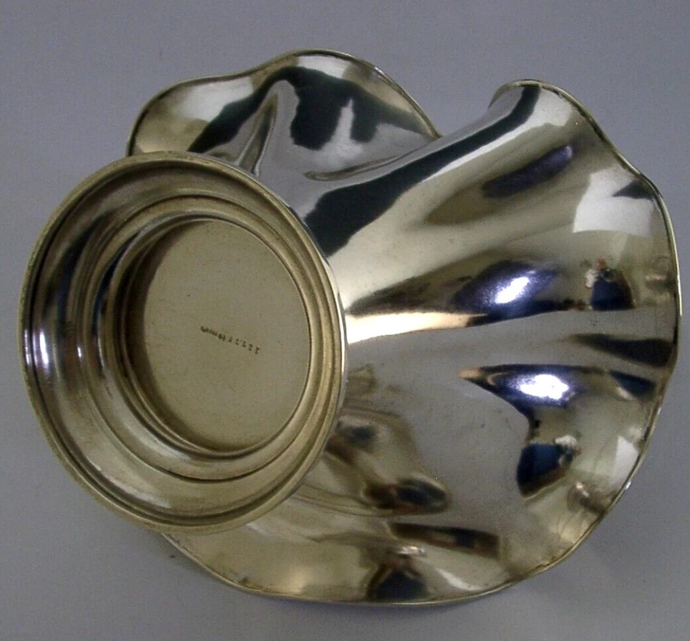 An antique solid silver Art Nouveau basket bowl with a fluted, lobed rim and an overhead twisted wire swing handle. View IX