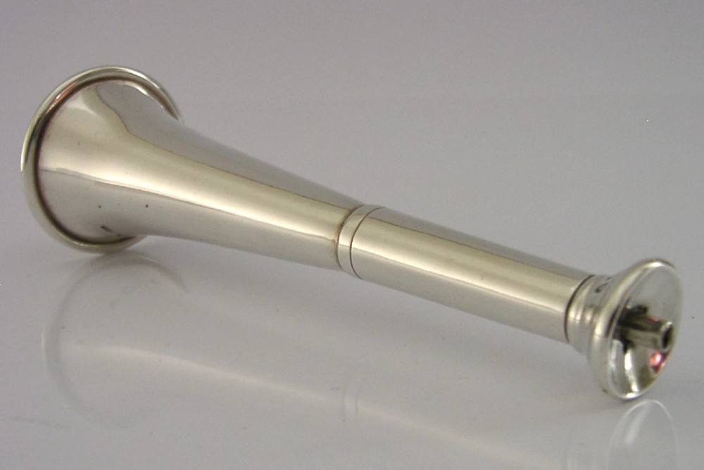 Victorian sterling silver table cigar lighter crafted in the shape of a flared fox hunting horn with British hallmarks visible near the base. View II