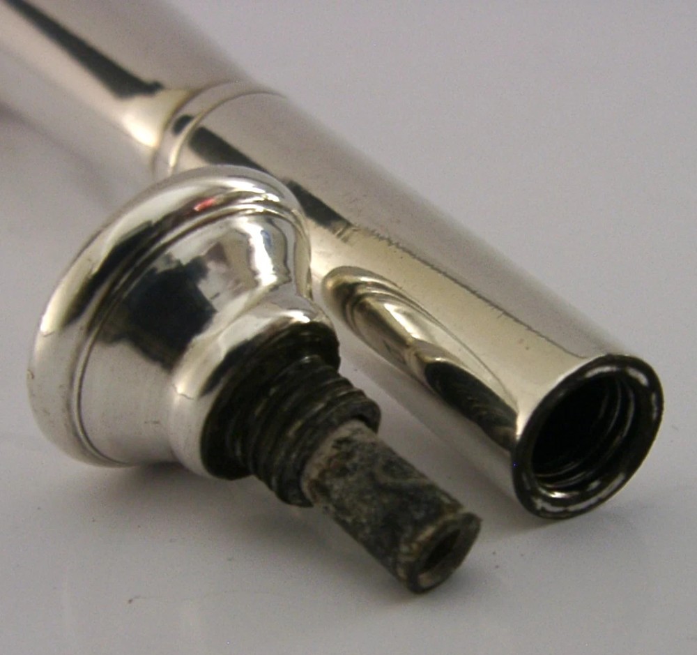 Victorian sterling silver table cigar lighter crafted in the shape of a flared fox hunting horn with British hallmarks visible near the base. View VI