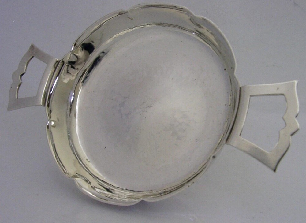 A planished sterling silver quaich featuring a lobed shallow bowl and two flat geometric handles. View VI